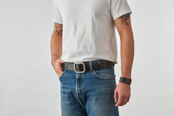 Style 011: Black belt with a repeating pattern of pyramid studs and hole punches