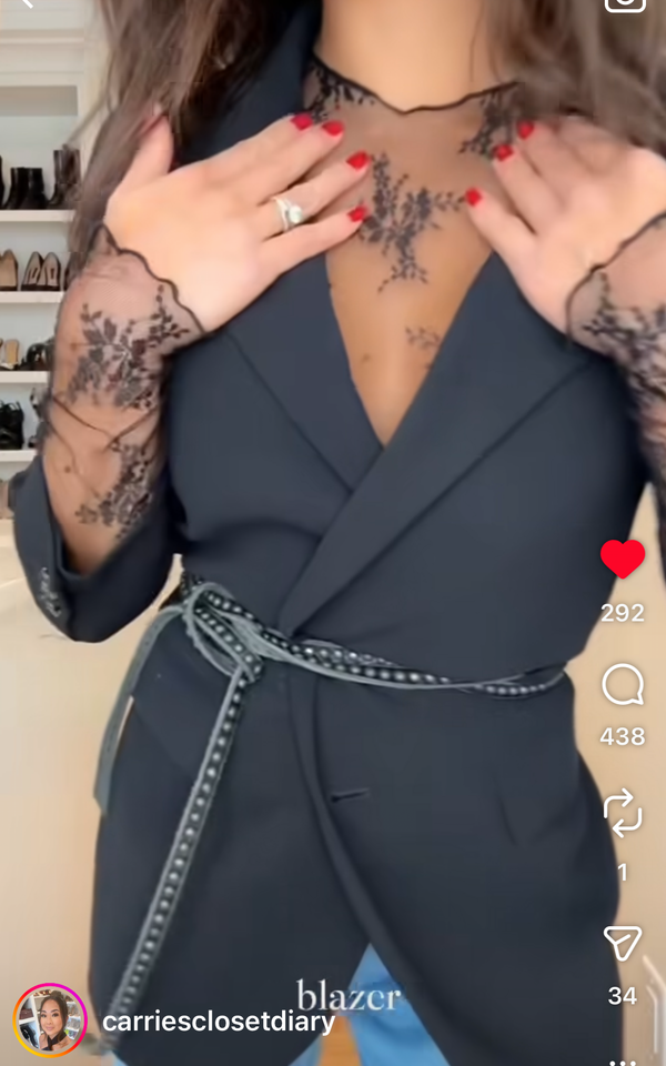 Woman earing a black blazer and thin leather tie belt