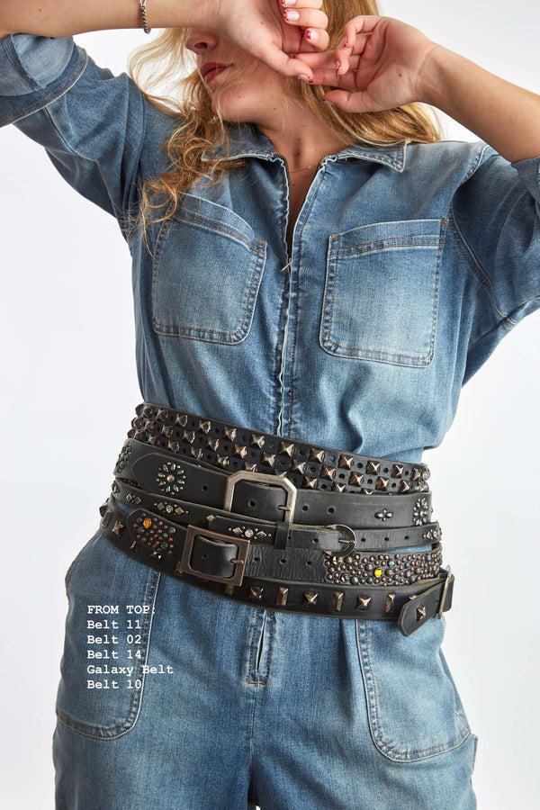 Woman wearing a denim outfit with 5 belts, from top belts 11, 02, 14, galaxy, and 10