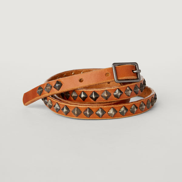 Style 013: Thin belt on tan leather with small, repeating pyramid studs