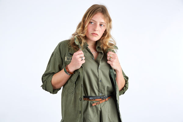 Style 013: Thin belt on tan leather with small, repeating pyramid studs