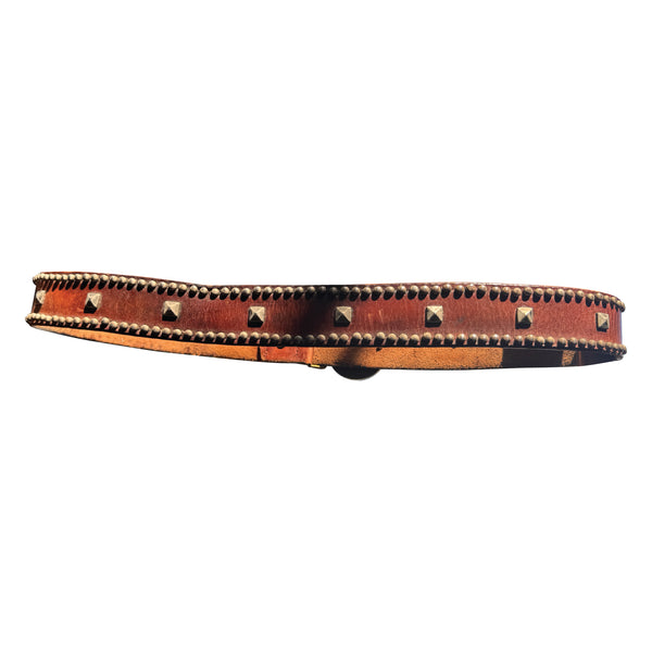 V11: Vintage belt on warm brown leather with ornate medallion buckle