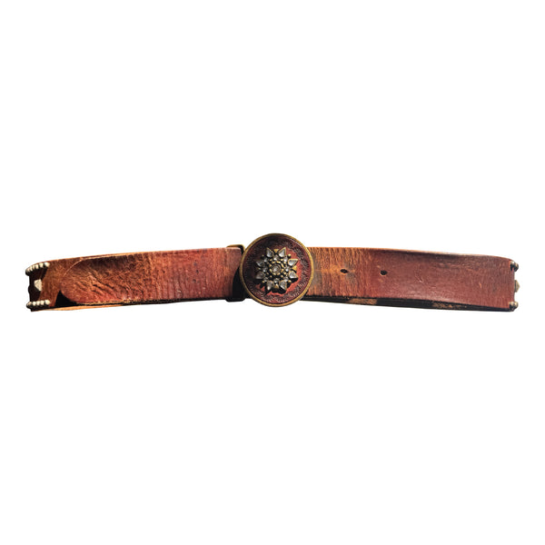 V11: Vintage belt on warm brown leather with ornate medallion buckle