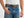 Man wearing a white shirt, blue jeans, and a brown leather belt with bottlecap studs